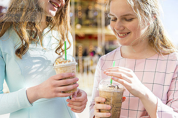 Russia  Moscow  teenage girls drinking a delicious frappe at funfair