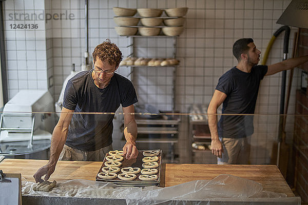 Bakers in bakery preparing fresh pretzls