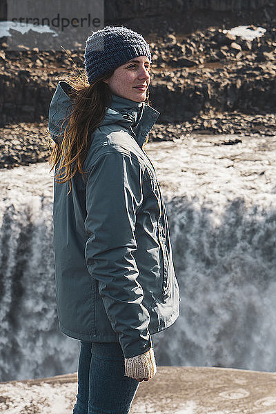 Iceland  woman standing at Dettifoss waterfall