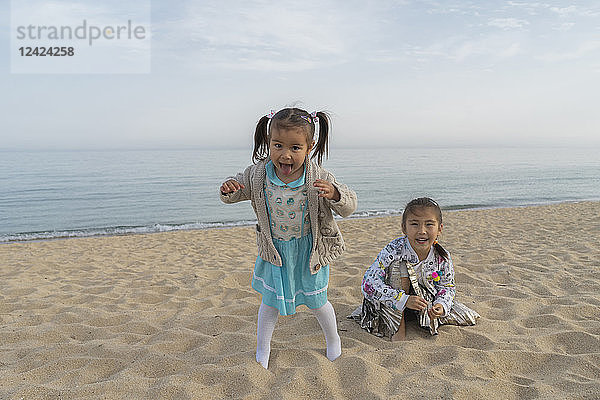 Portrait of two happy girls on the beach