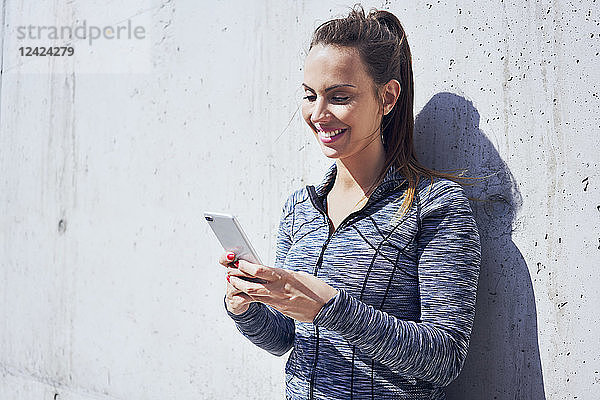 Portrait of happy woman using her smartphone
