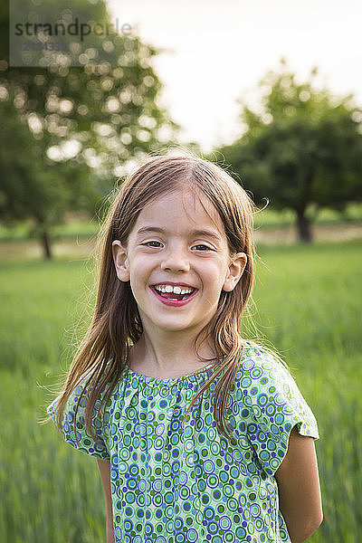 Portrait of happy little girl in nature