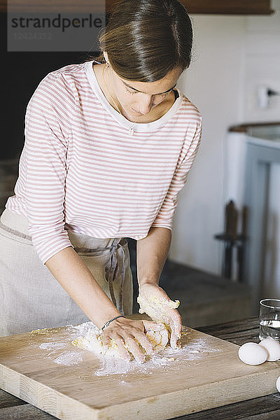 Woman preparing dough  flour and eggs