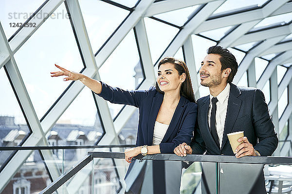 Businesswoman and businessman talking in modern office