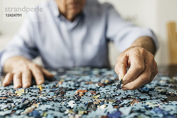 Senior man doing a jigsaw