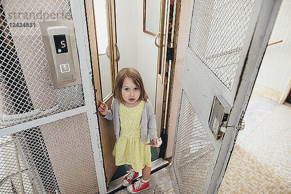 Portrait of little girl leaving lift