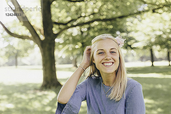 Portrait of happy young woman in a park