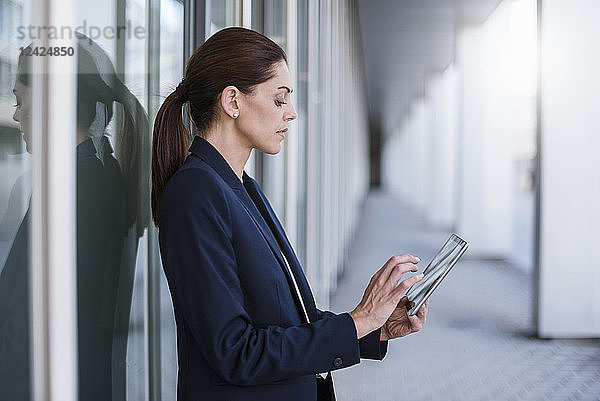 Businesswoman using tablet outdoors