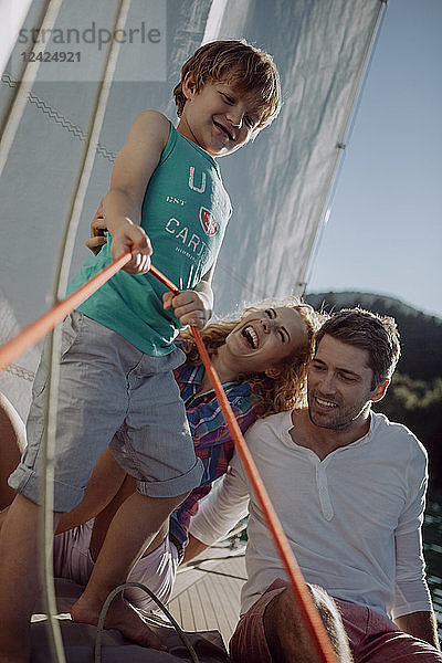 Happy family on a sailing boat