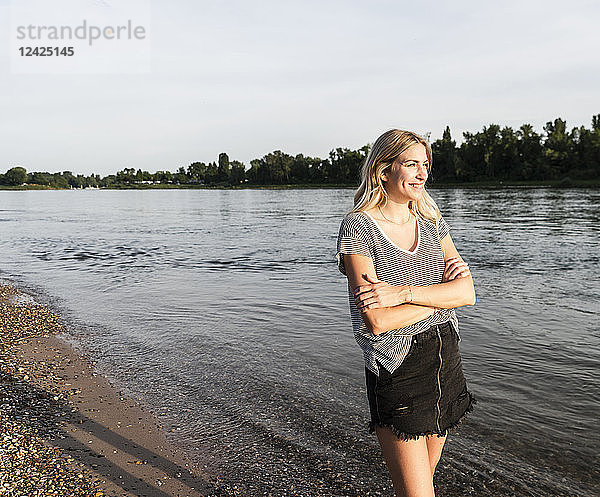 Blond woman at riverside in the evening