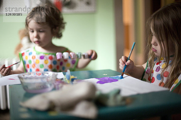 Baby Junge und Mädchen malen am Tisch zu Hause