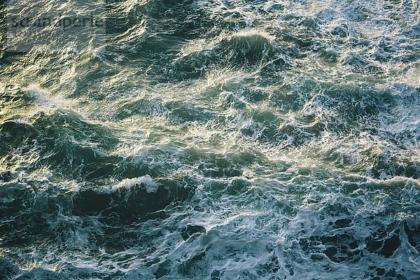 Krachende Wellen und Brandung  grüne und türkise Farben im Meer  Blick von oben.