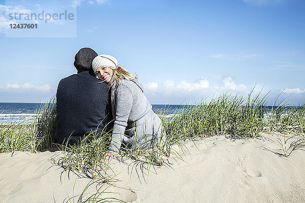 Couple sitting in dunes