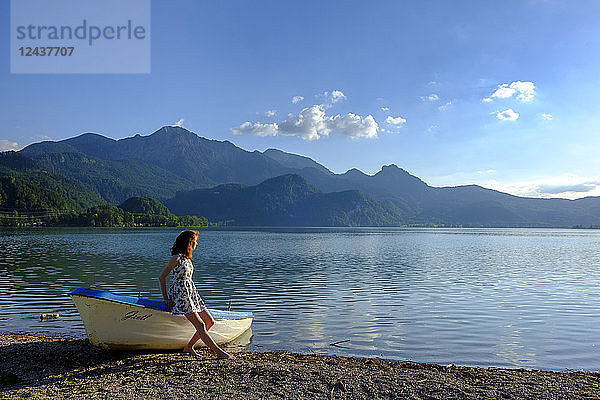 Germany  Bavaria  Upper Bavaria  Heimgarten  teenage girl leaning on boat at Kochelsee