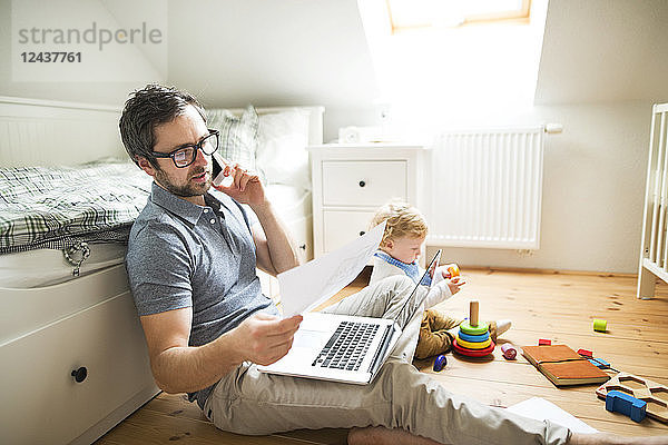 Father with his little son working from home