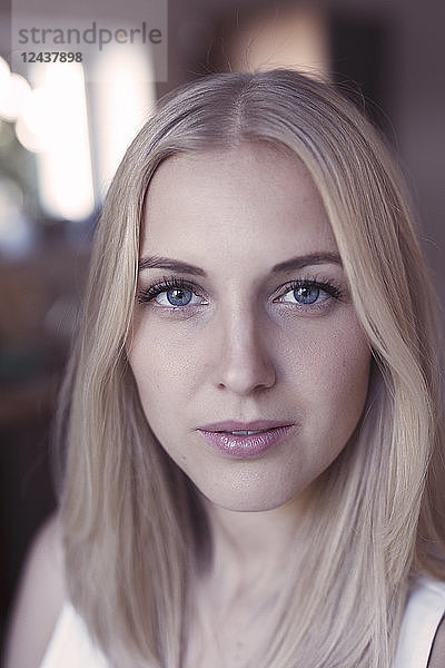 Portrait of young blond woman with blue eyes