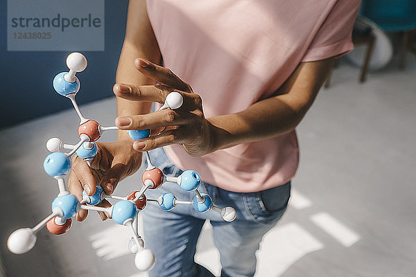 Female scientist holding molecule model
