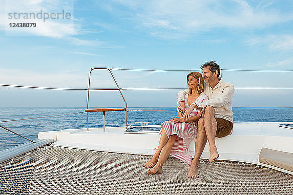 Mature couple enjoying quality time on sailing trip on a catamaran