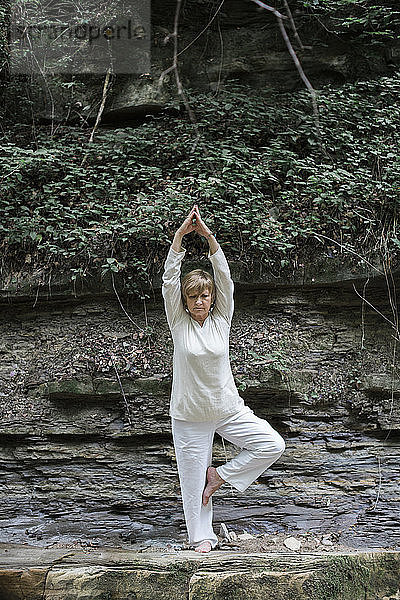 Senior woman doing yoga  tree position