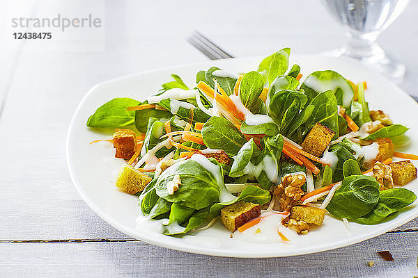Autumnal salad with lamb's lettuce  carrots  slaw  croutons and walnuts