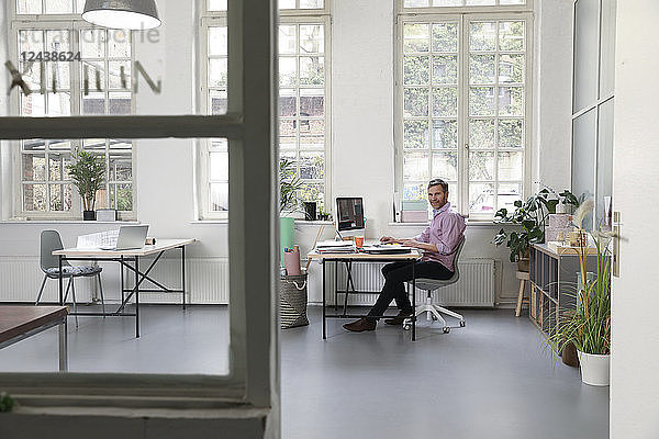 Man working at desk in a loft office