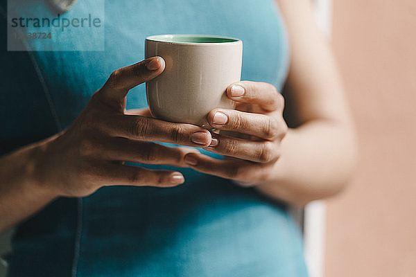 Woman holding cup of coffee  close up