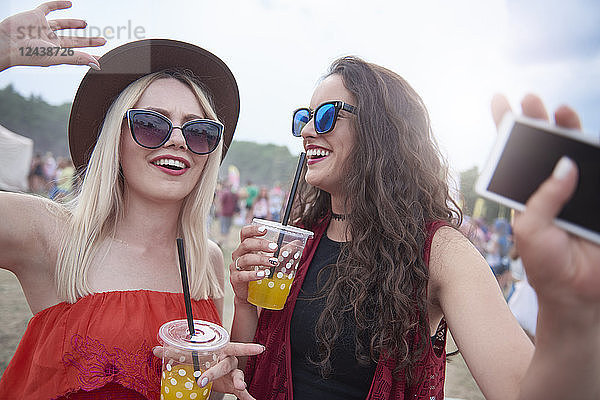 Portrait of women with plastic cups at the music festival