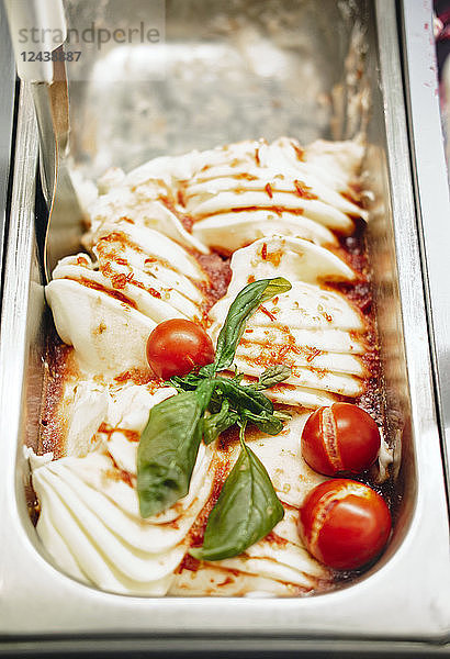 Italian ice cream with cherry tomatoes and basil