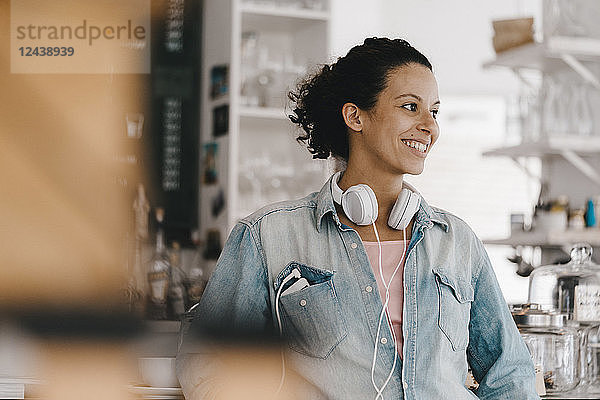 Young woman with headphones  working in coworking space