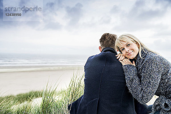 Couple sitting in dunes