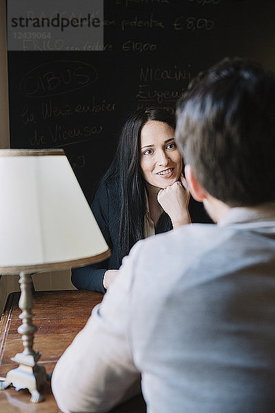 Elegant couple talking in a cafe