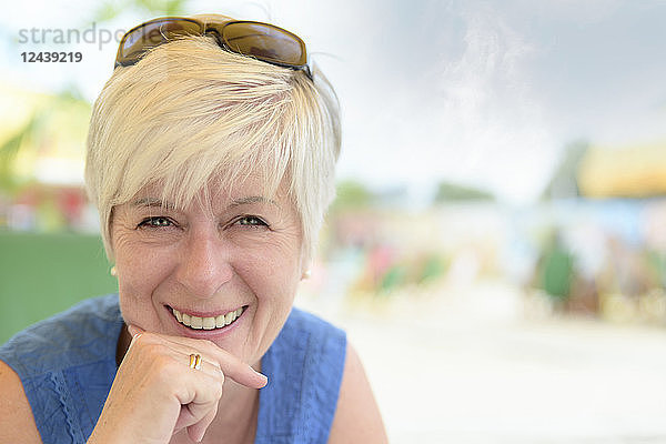 Portrait of smiling senior woman at beach bar