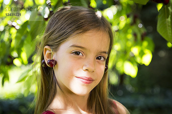 Little girl with cherries on ears