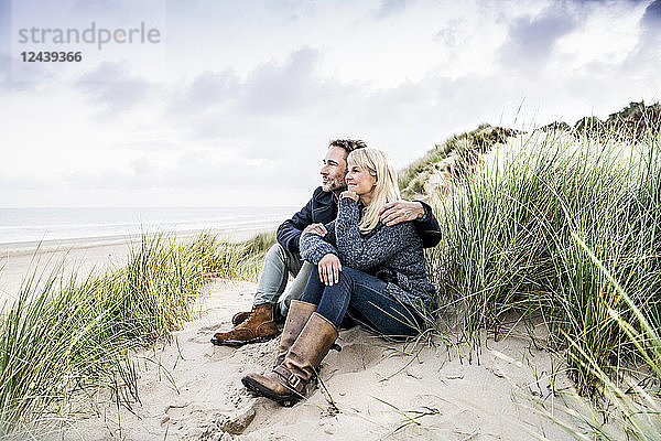 Couple sitting in dunes