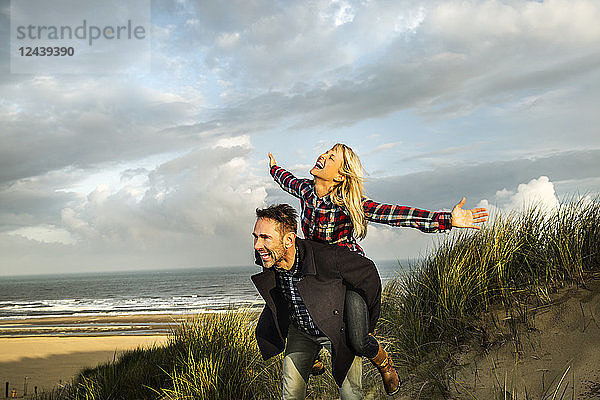 Happy playful couple in dunes