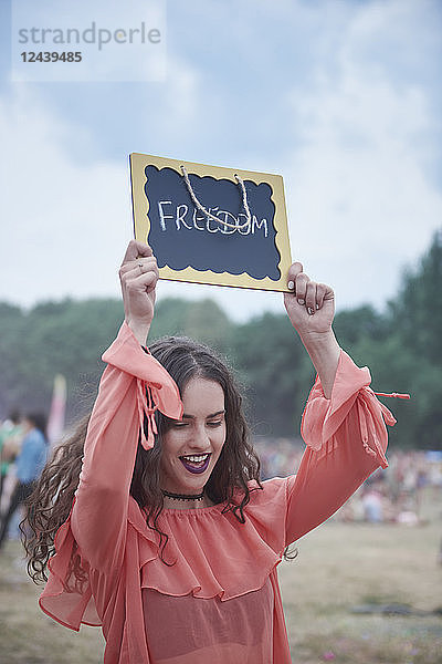 Woman holding sign at music festival  freedom