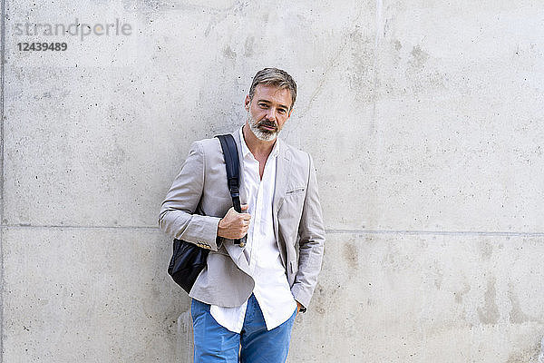 Portrait of casual businessman with backpack