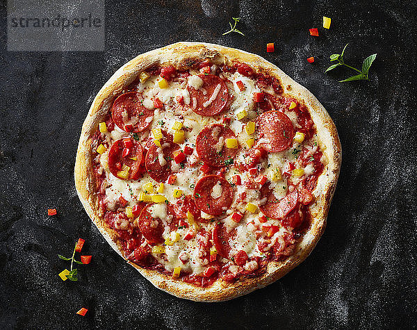 Salami pizza on dark ground
