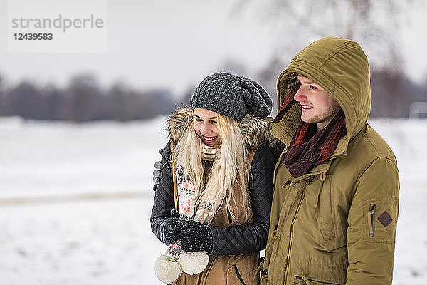Happy young couple in park on a snowy day