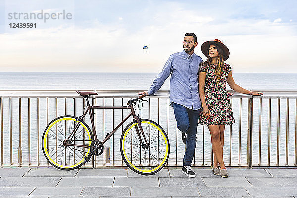 Spain  Barcelona  couple with bicycle standing at the seaside