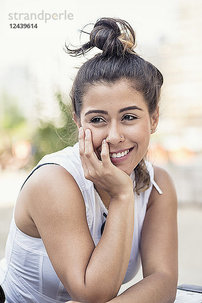 Portrait of smiling young woman with bun