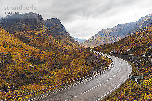 UK  Scotland  scenic road through the mountains in the Scottish highlands near Glencoe with a view on the Three Sisters