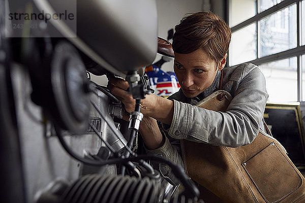 Woman working in repair workshop