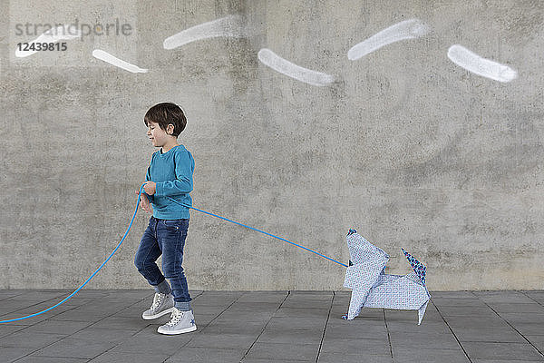 Little boy with origami dog