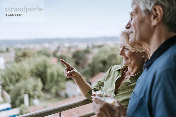 Senior couple talking on balcony