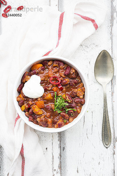 Bowl of Chili con Carne with fresh coriander and sour cream