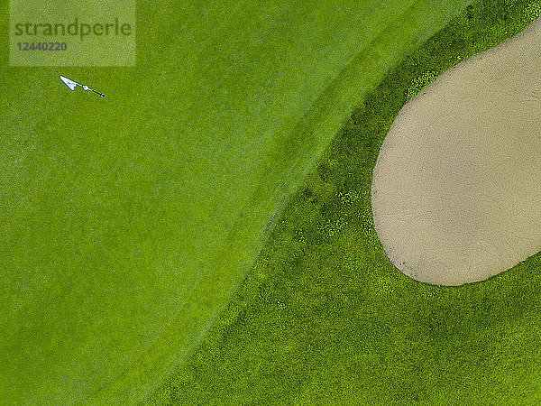 Germany  Baden-Wuerttemberg  Aerial view of golf course with bunker  green  hole and golf flag