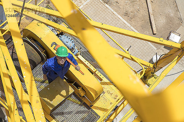 Construction worker standing on crane