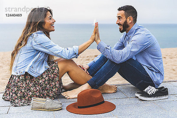 Spain  Barcelona  couple having fun together on the beach