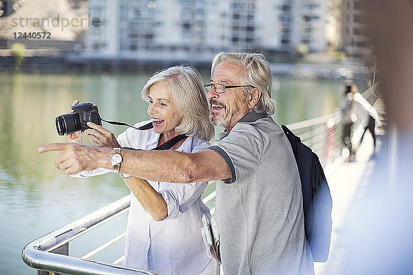 Senior couple taking a city break  taking photos